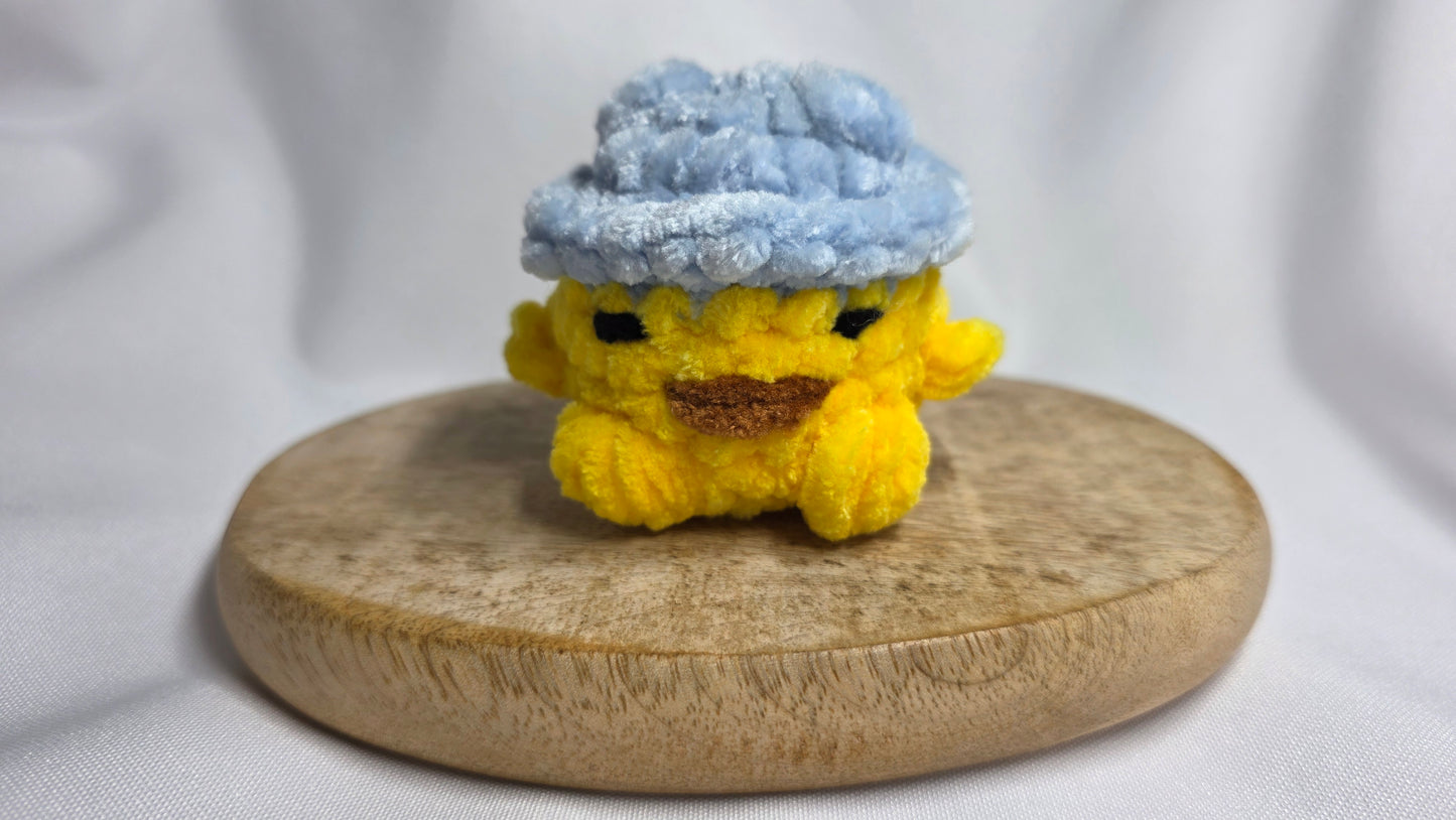 Léon le poussin à chapeau